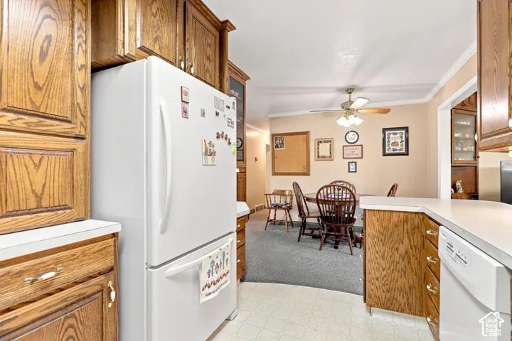 Kitchen featuring wood cabinetry, light countertops, and a built-in dishwasher