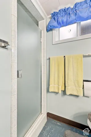 Frosted glass shower enclosure with tiled surround