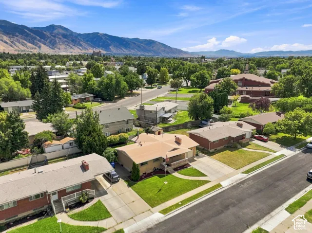 Suburban property featuring mature trees and mountain scenery
