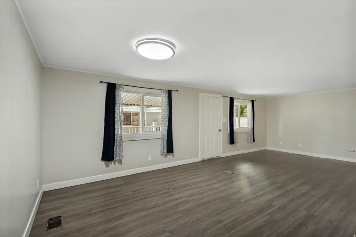 Neutral tone wall paint with crisp white trim, recessed lighting, and wood-finish flooring