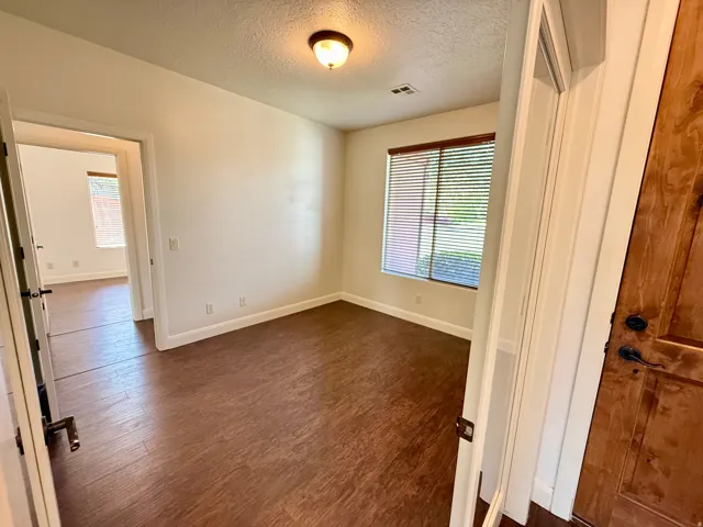 Wood-finish flooring, neutral wall tones, and recessed lighting