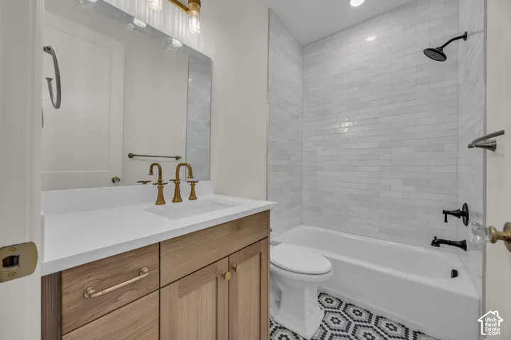Wood-finish vanity with a white countertop and gold-tone fixtures