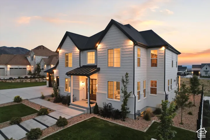 Modern exterior featuring white siding and a black shingled roof