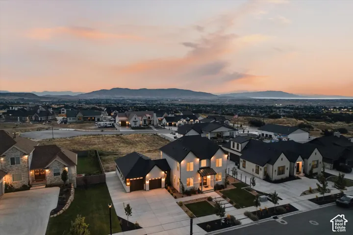 Modern residential development featuring single-family homes with mountain and water backdrops