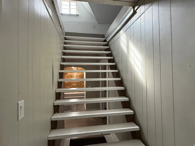 Vertical paneled wall detailing and a window with grid accents