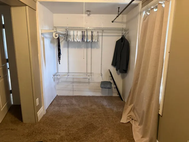 Built-in closet organization system with adjustable shelving and multiple hanging rods