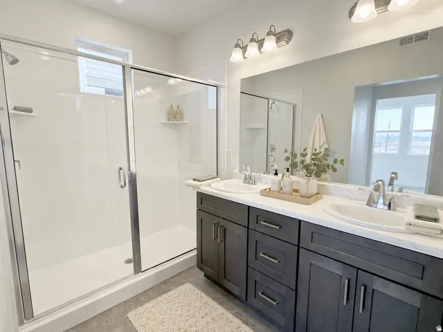 Dual vanity with undermount sinks and dark wood-finish cabinetry