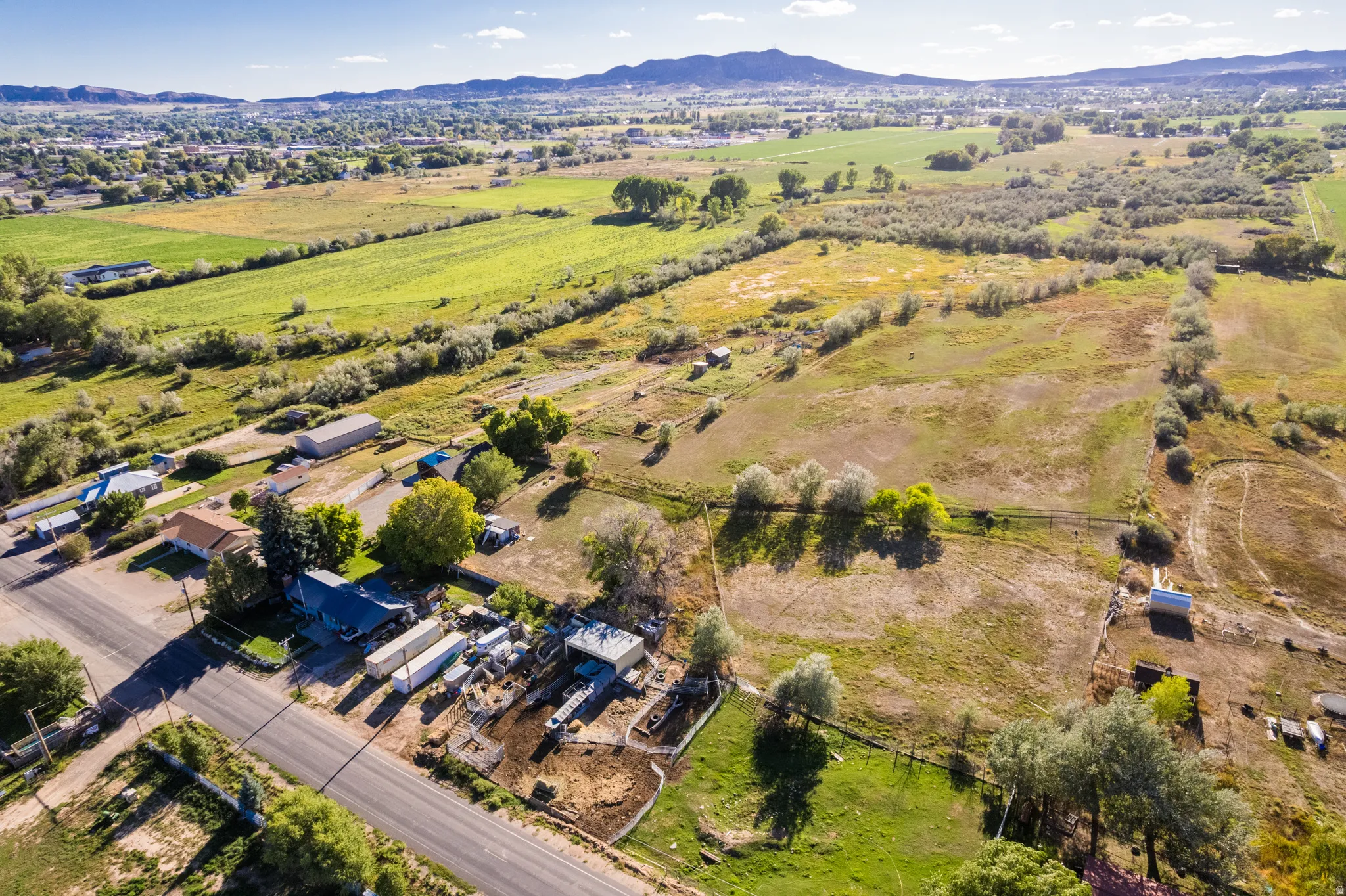 Expansive rural landscape featuring a mix of cultivated fields and natural terrain