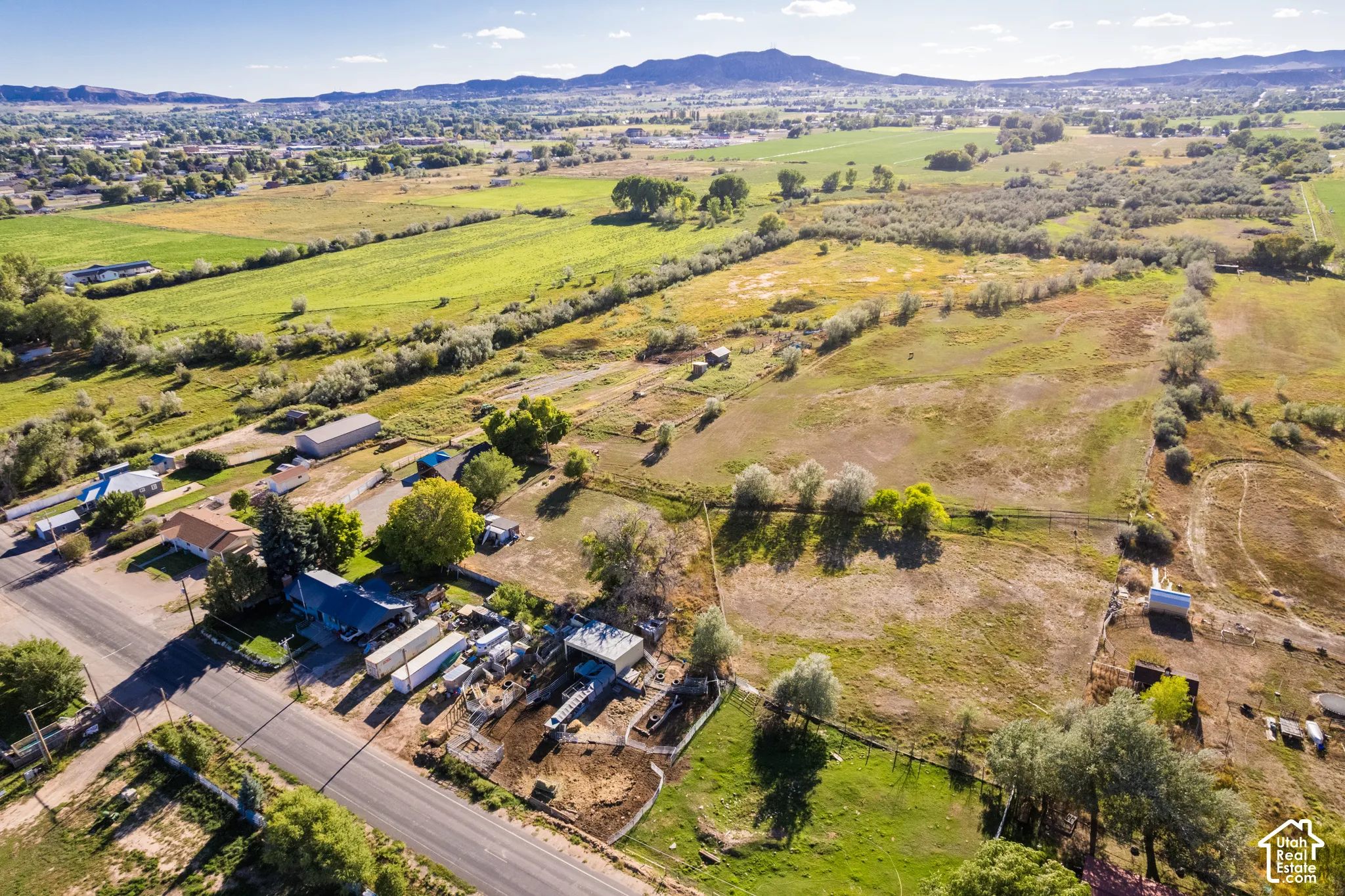 Expansive rural landscape featuring a mix of cultivated fields and natural terrain