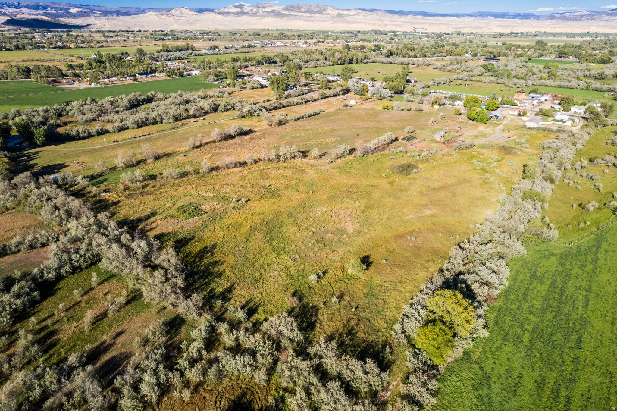 Expansive rural property featuring open fields and distant mountains