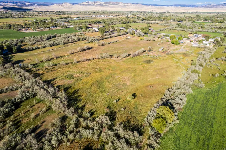 Expansive rural property featuring open fields and distant mountains