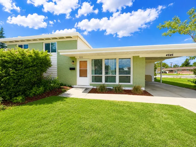 Split-level exterior featuring light green and white siding