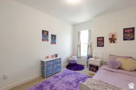 Neutral wall paint, window with drapes, and carpeted flooring