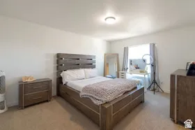 Recessed lighting, light-colored walls, window with natural light, and carpeted flooring