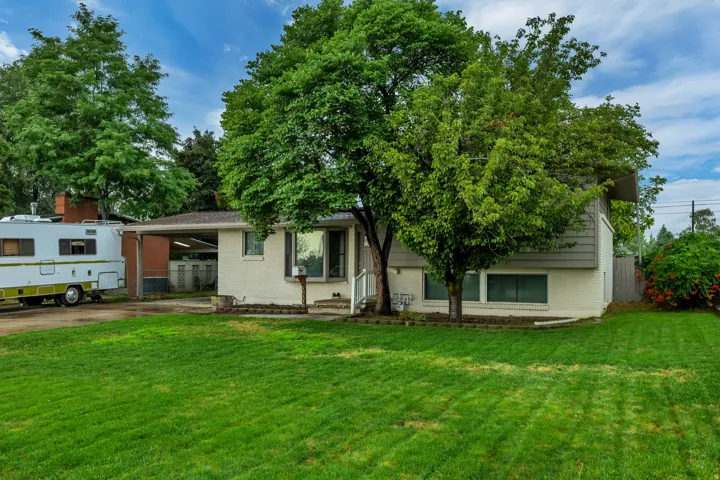 Brick and siding exterior with mature trees