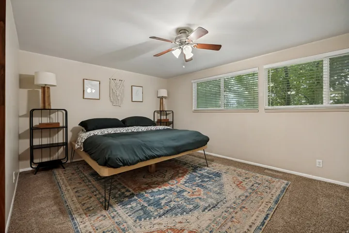 Wall-to-wall carpeting and multiple windows with blinds