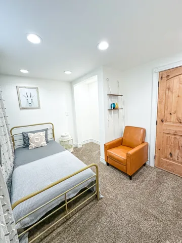 Recessed lighting, wood-finish interior door, recessed wall niche, and wall-to-wall carpeting