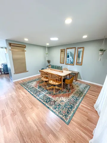 Recessed lighting, wood-finish flooring, light gray wall color, and a circular ceiling light fixture