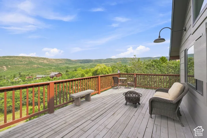 Expansive outdoor deck with wood-finish flooring and a full-height railing