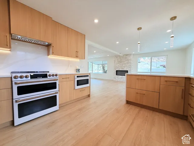 Wood-finish flooring throughout, complemented by light wood cabinetry and white countertops