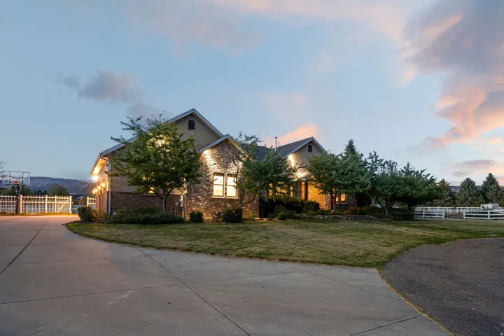 Stone and siding exterior with mature landscaping