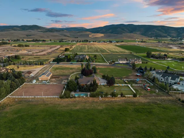 Expansive property featuring a pool, surrounding green spaces, and a barn structure