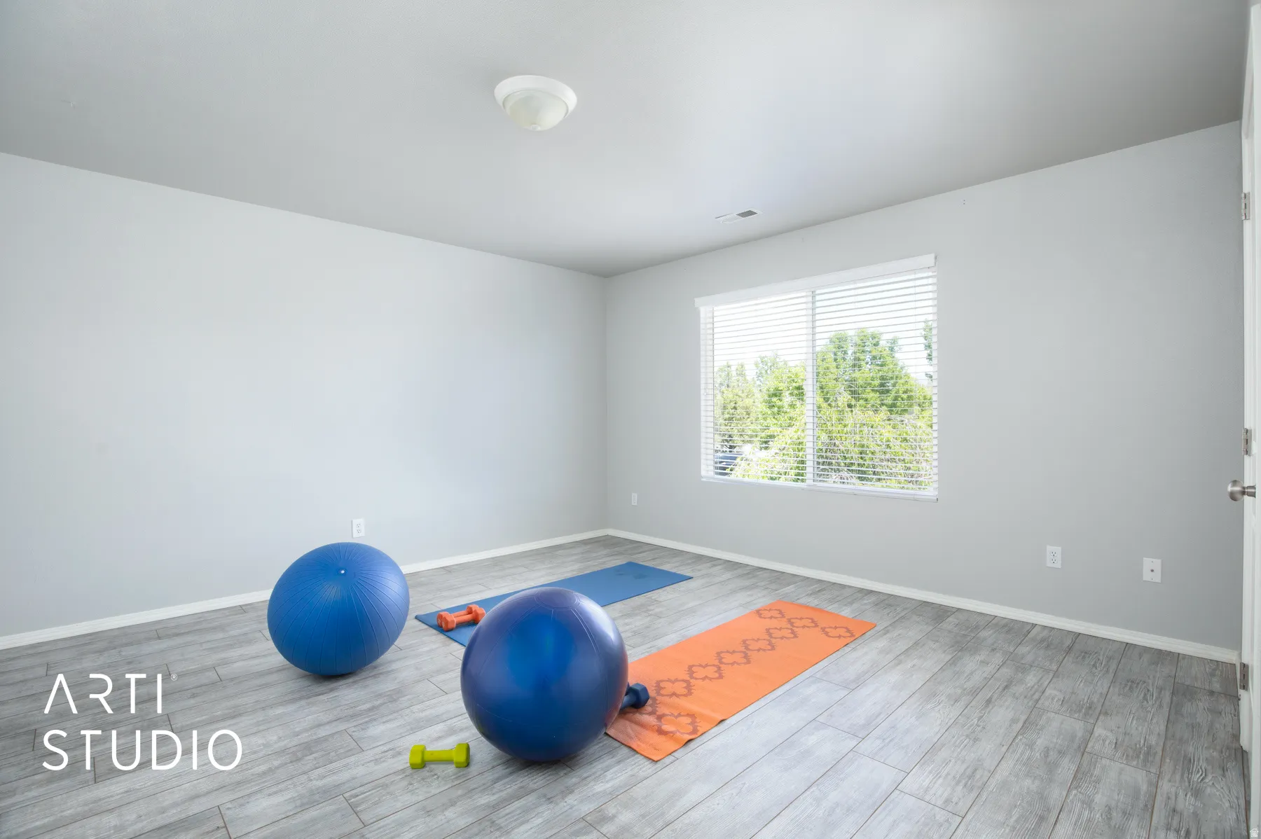Recessed lighting, wood-finish flooring, white walls, and a window with blinds