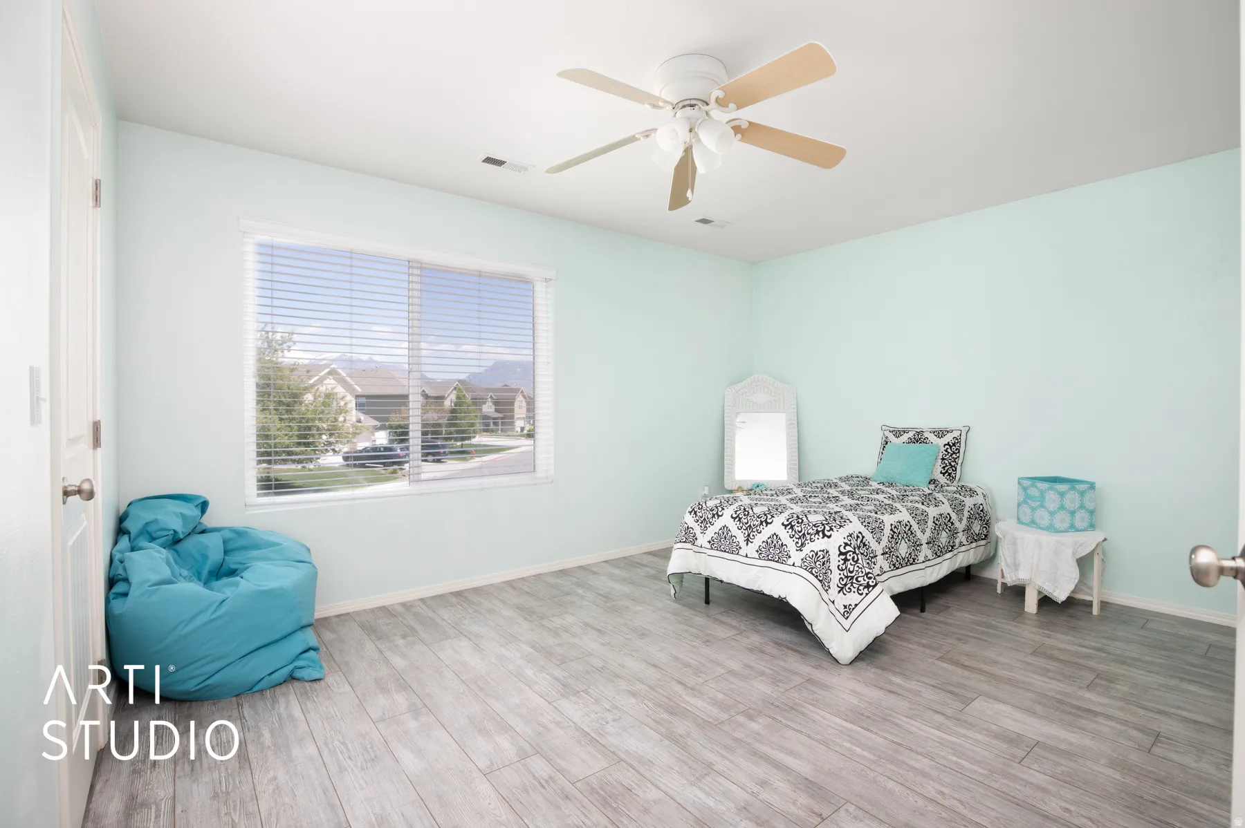 Wood-finish flooring, light-colored walls, window with horizontal blinds, and a ceiling fan with integrated lighting