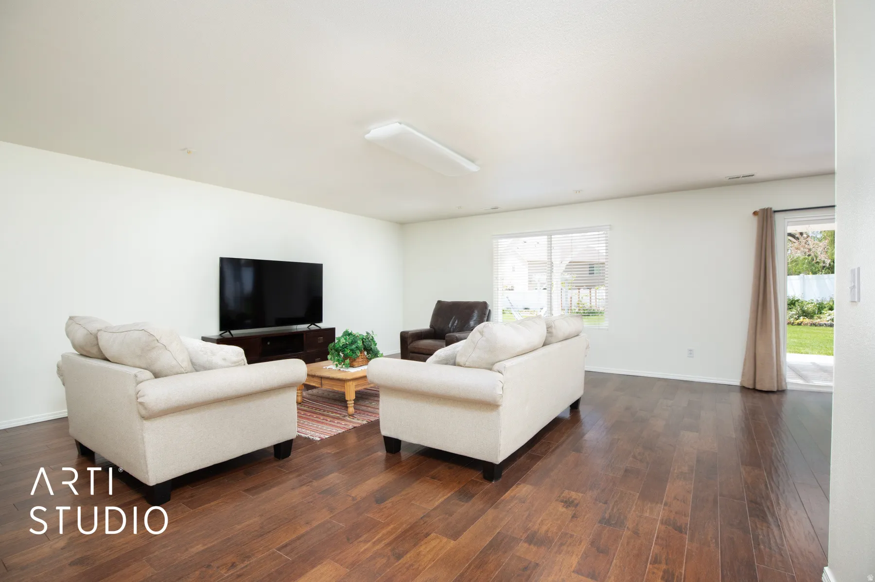 Wood-finish flooring, white walls, and a sliding glass door to the exterior