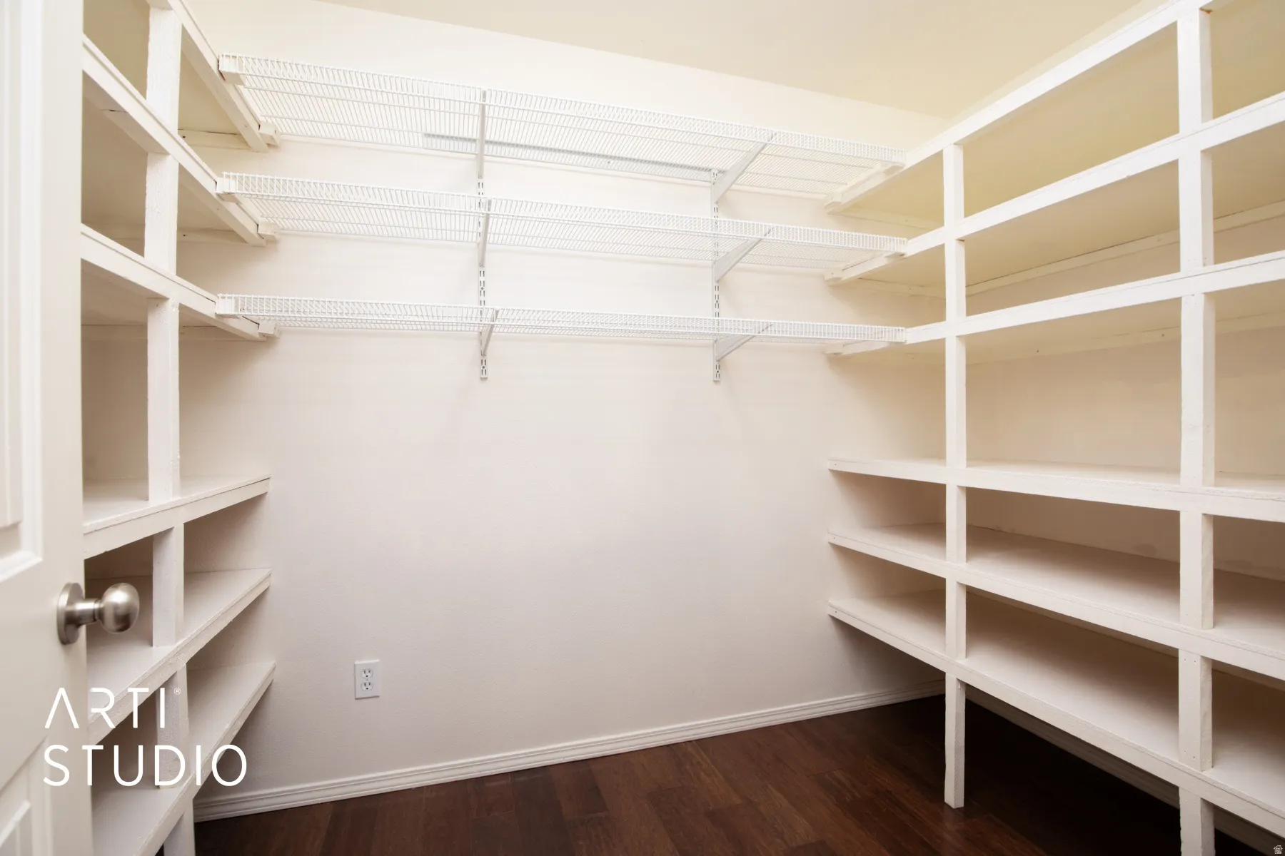Custom built-in shelving, adjustable wire shelving, dark wood-finish flooring, white door with brushed nickel hardware, and neutral wall finishes