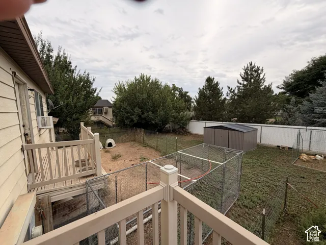 Rear exterior with siding, elevated deck, and a fenced yard