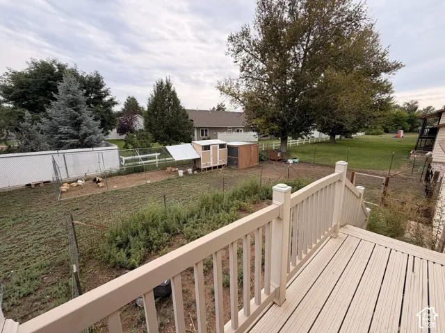 Composite deck with railings and steps overlooking a fenced backyard