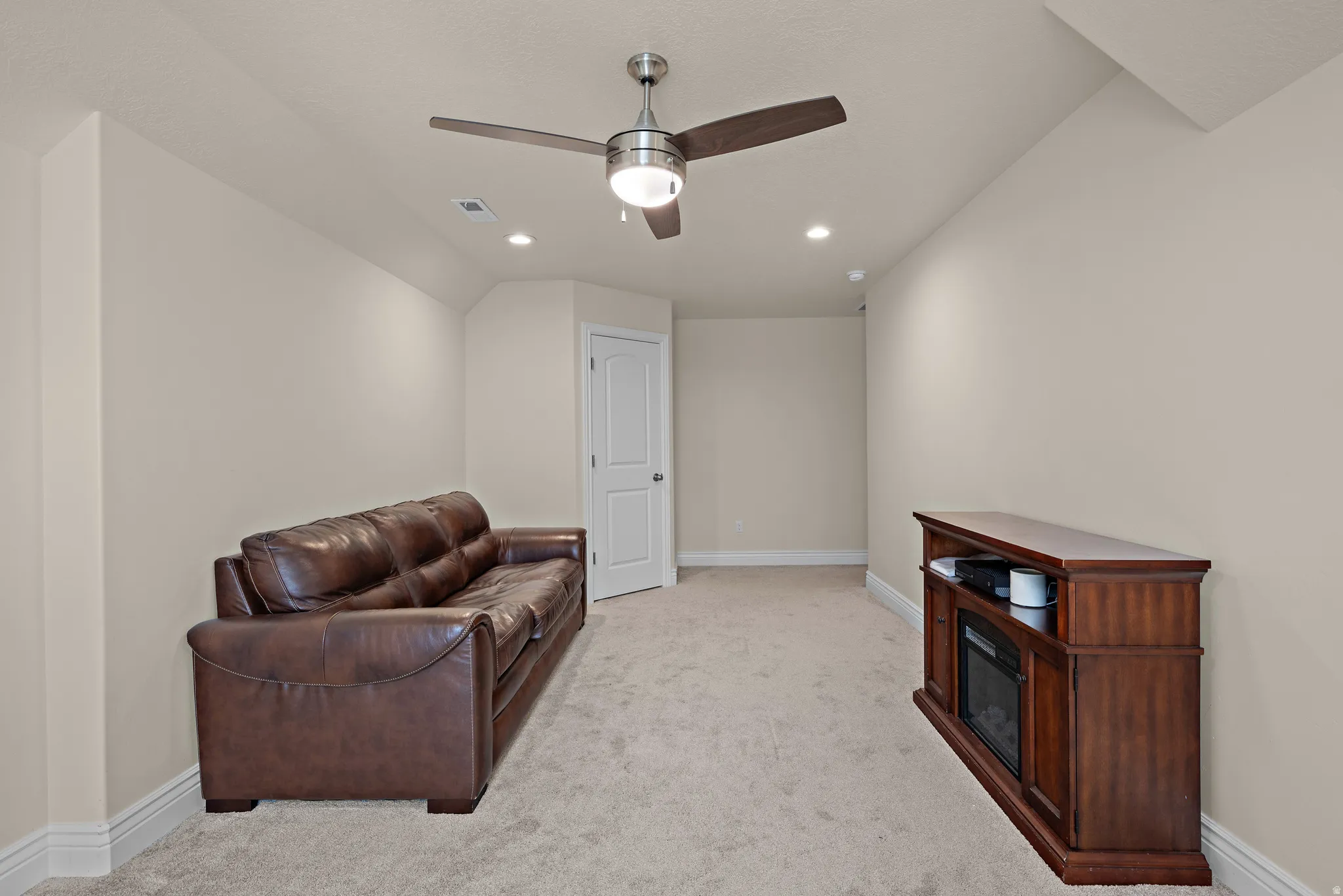 Recessed lighting, ceiling fan, neutral wall paint, carpet flooring, and white trim