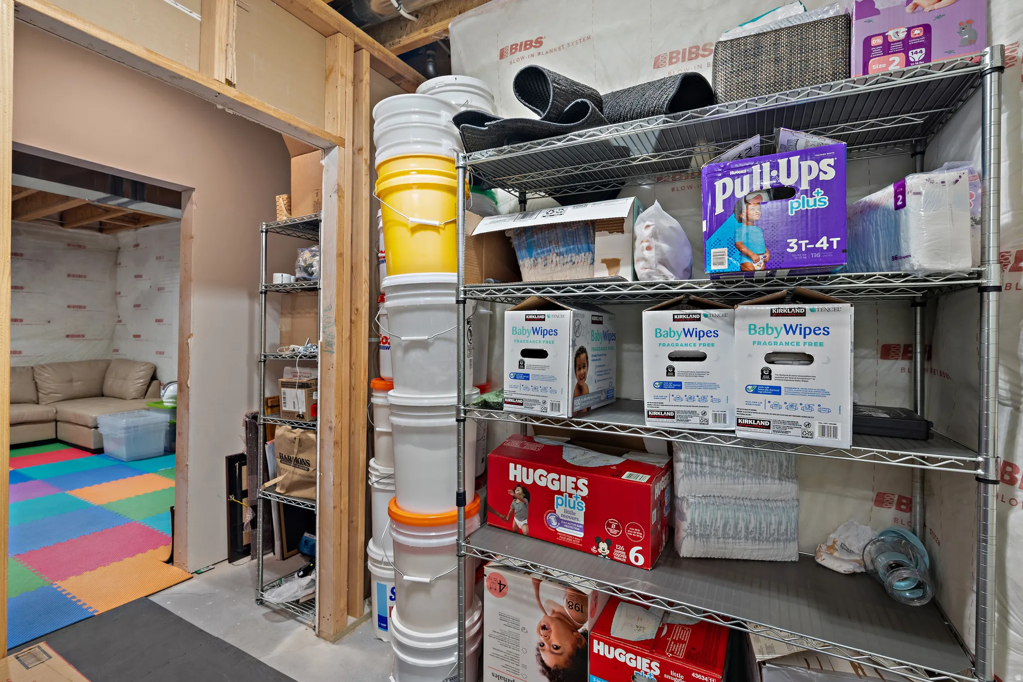 Unfinished basement area featuring exposed ceiling joists and wall studs