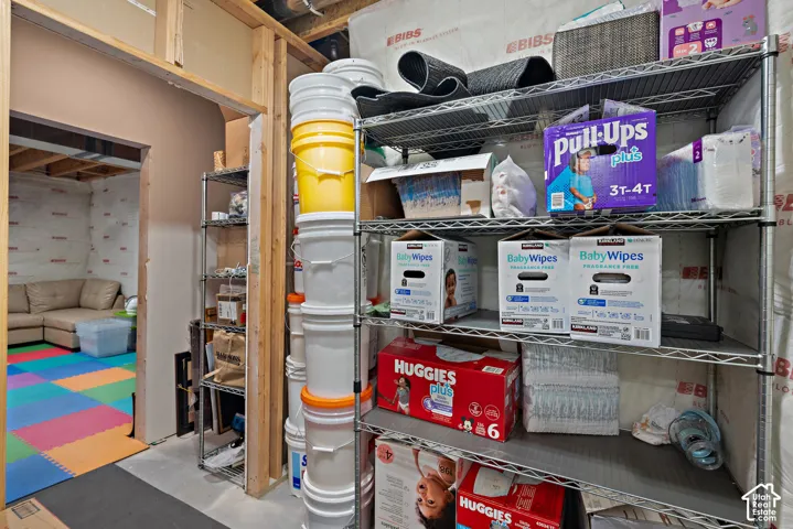 Unfinished basement area featuring exposed ceiling joists and wall studs