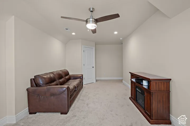 Recessed lighting, ceiling fan, neutral wall paint, carpet flooring, and white trim