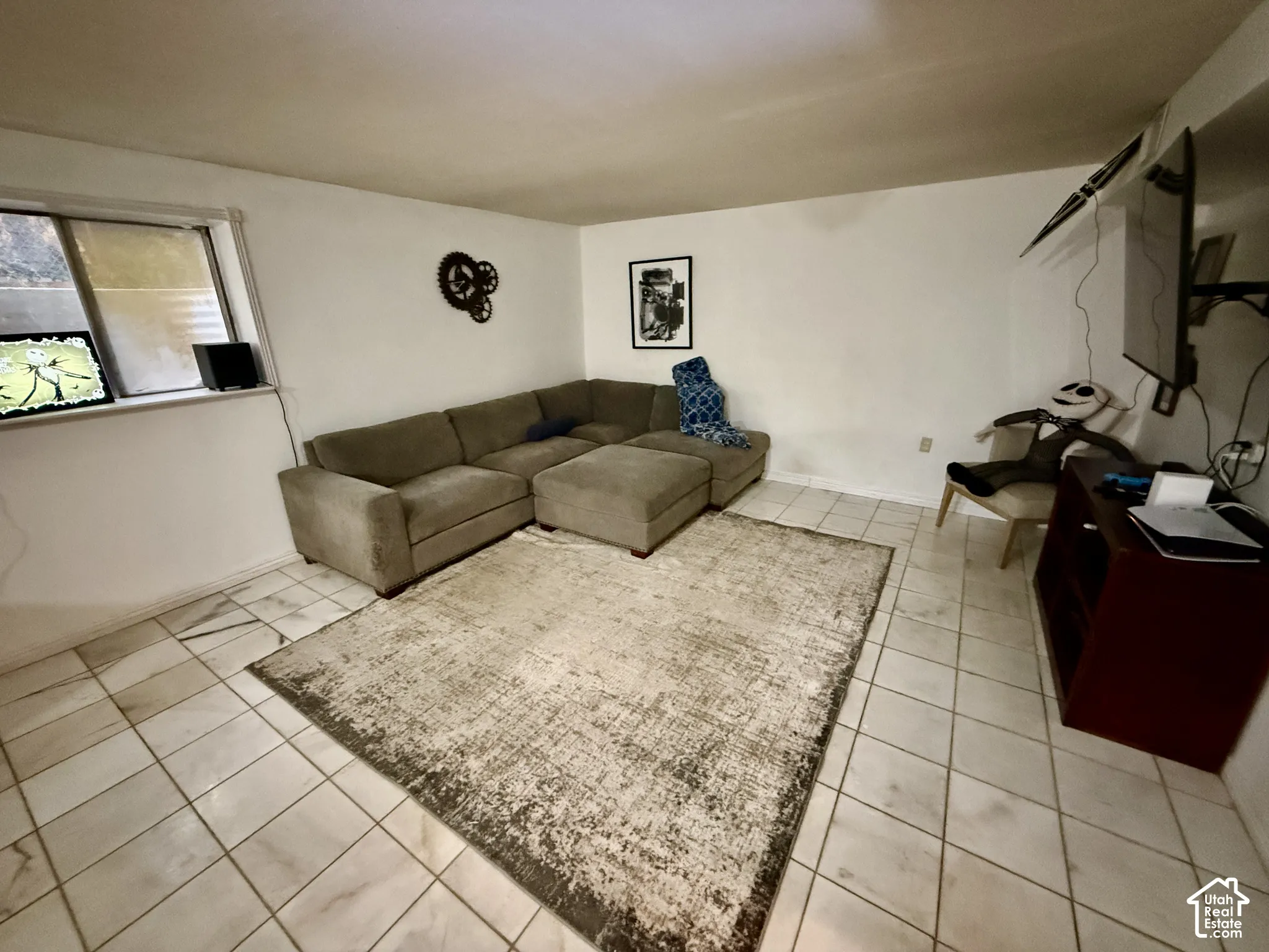 Tiled flooring throughout with a window on the far wall