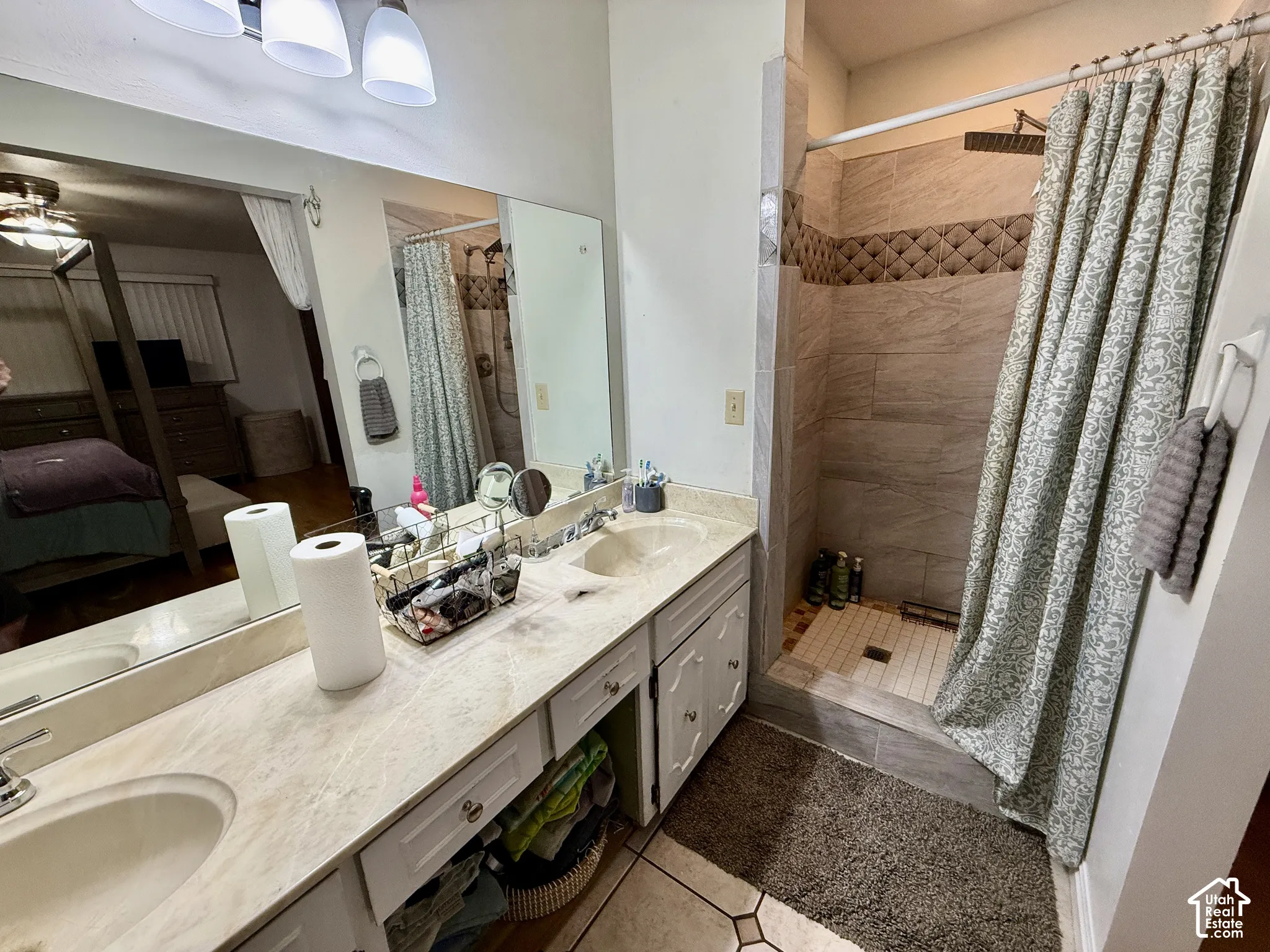 Dual vanity with integrated sinks, light-toned countertop, and white cabinetry