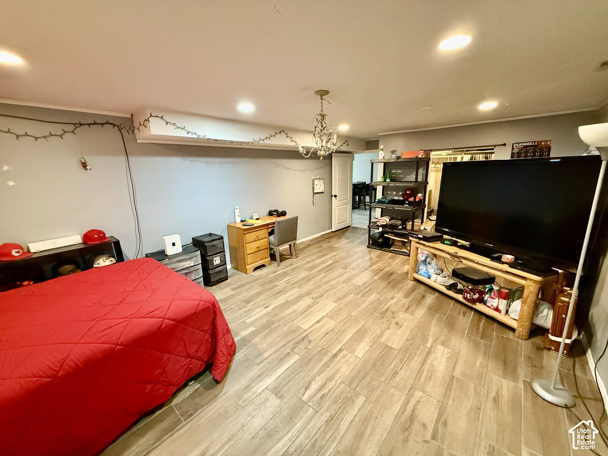Recessed lighting, wood-finish flooring, and a chandelier fixture