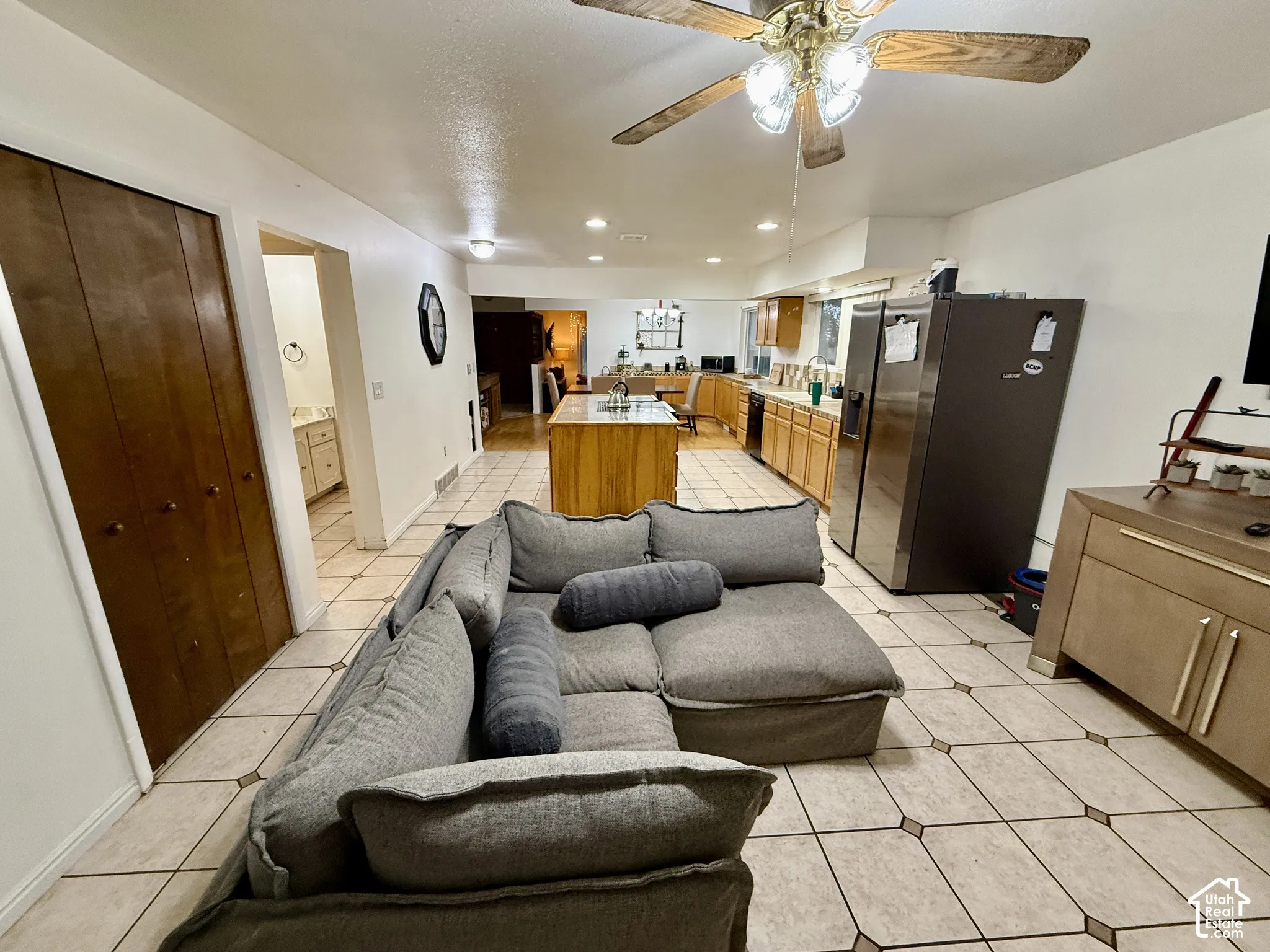 Tile flooring, recessed lighting, and a ceiling fan with integrated lighting