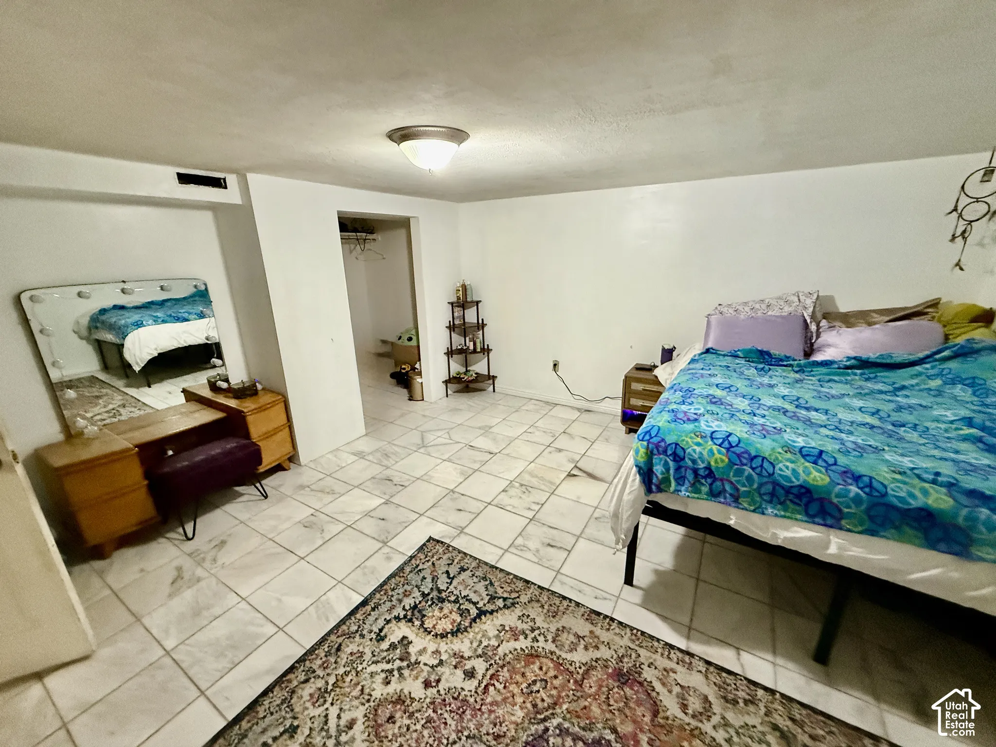 White tile flooring with a semi-flush mount ceiling light fixture