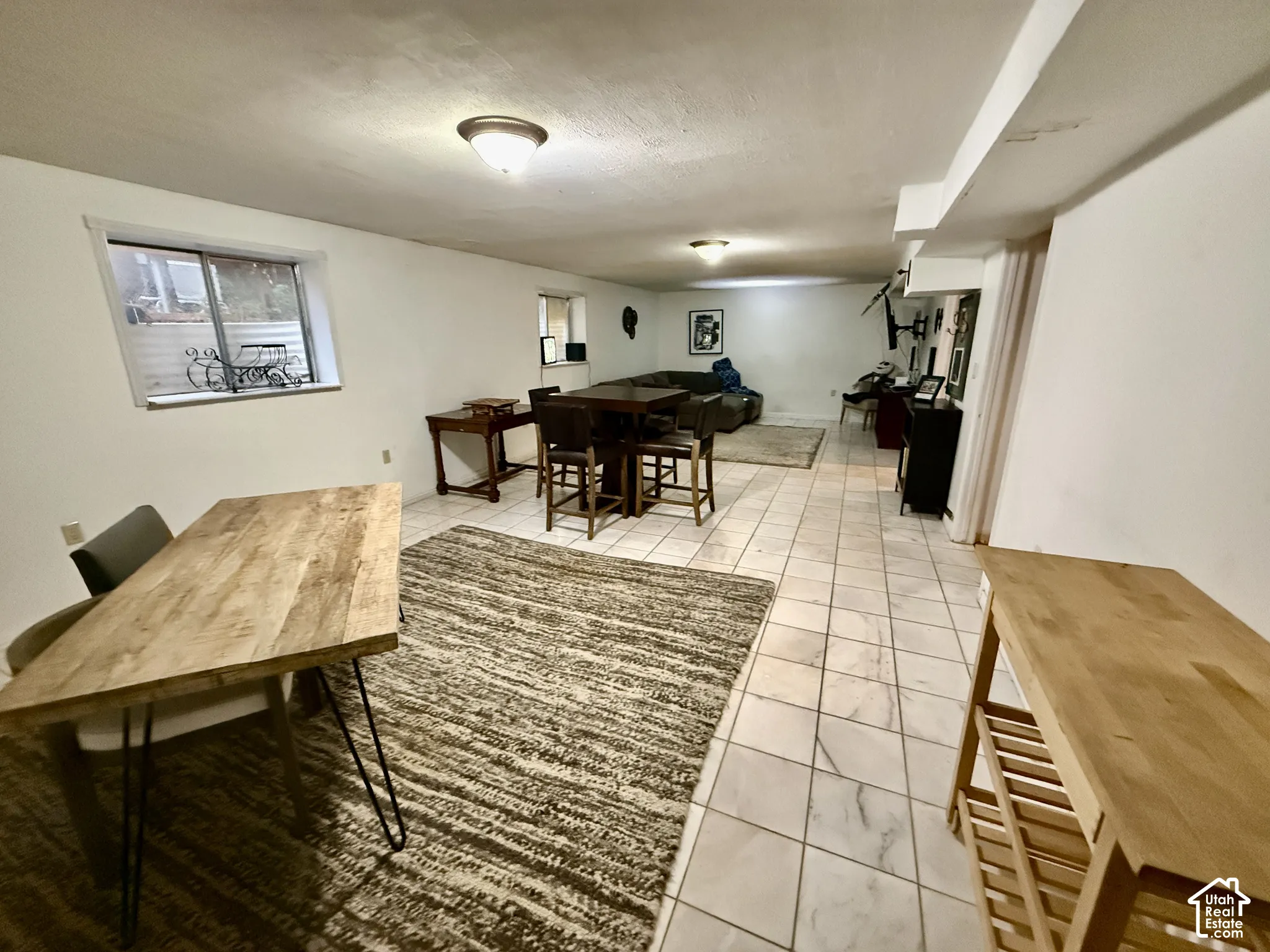 Recessed lighting and a single window define this expansive area