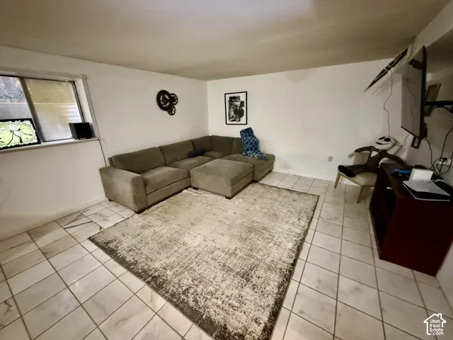 Tiled flooring throughout with a window on the far wall