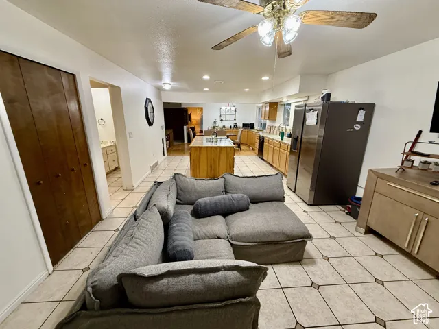 Tile flooring, recessed lighting, and a ceiling fan with integrated lighting