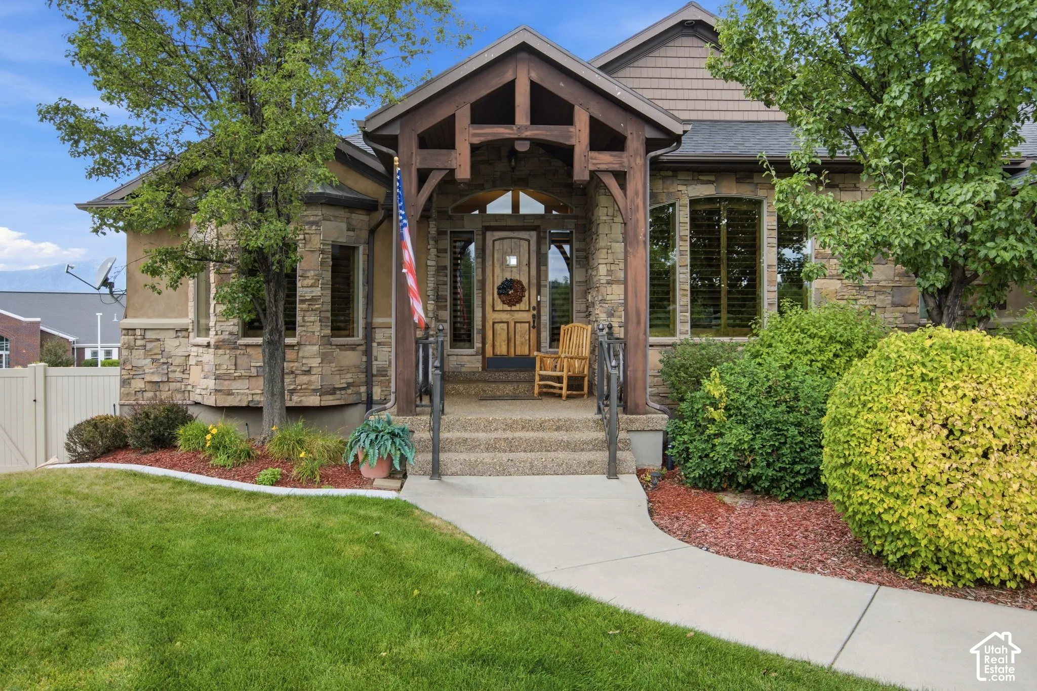 Stone and stucco exterior with a prominent timber-framed entry