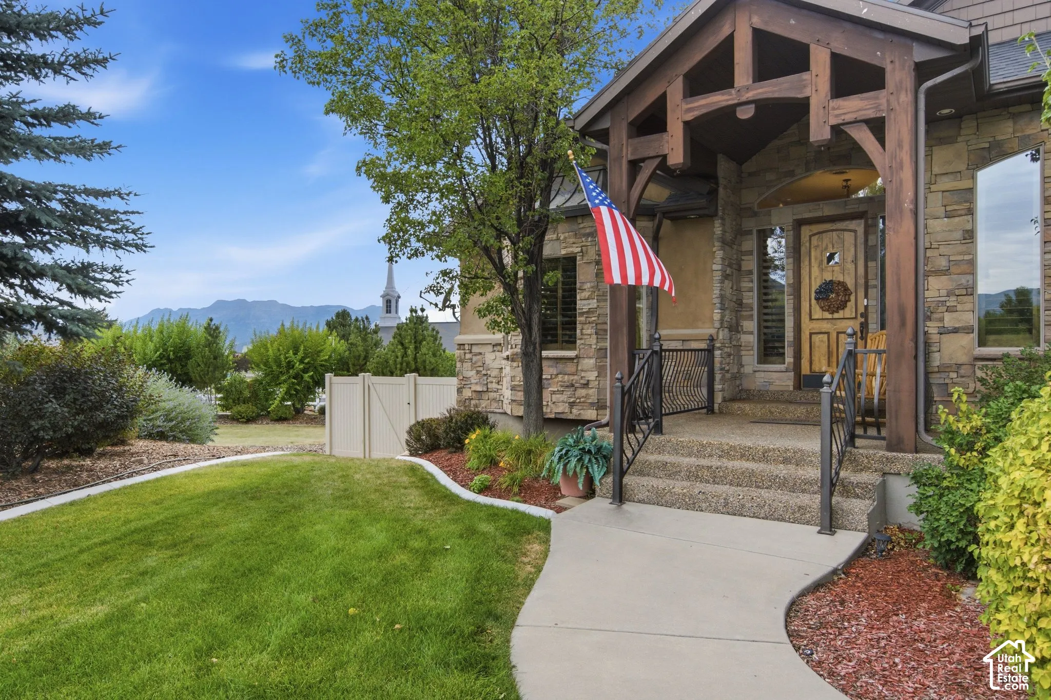Stone veneer exterior with a prominent wooden beam entryway