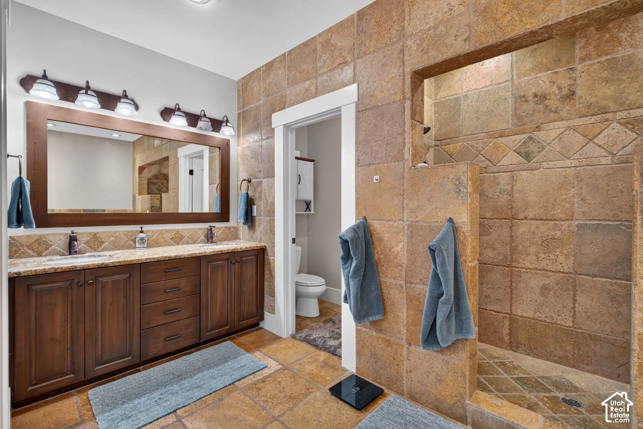 Dual vanity with undermount sinks and wood-finish cabinetry