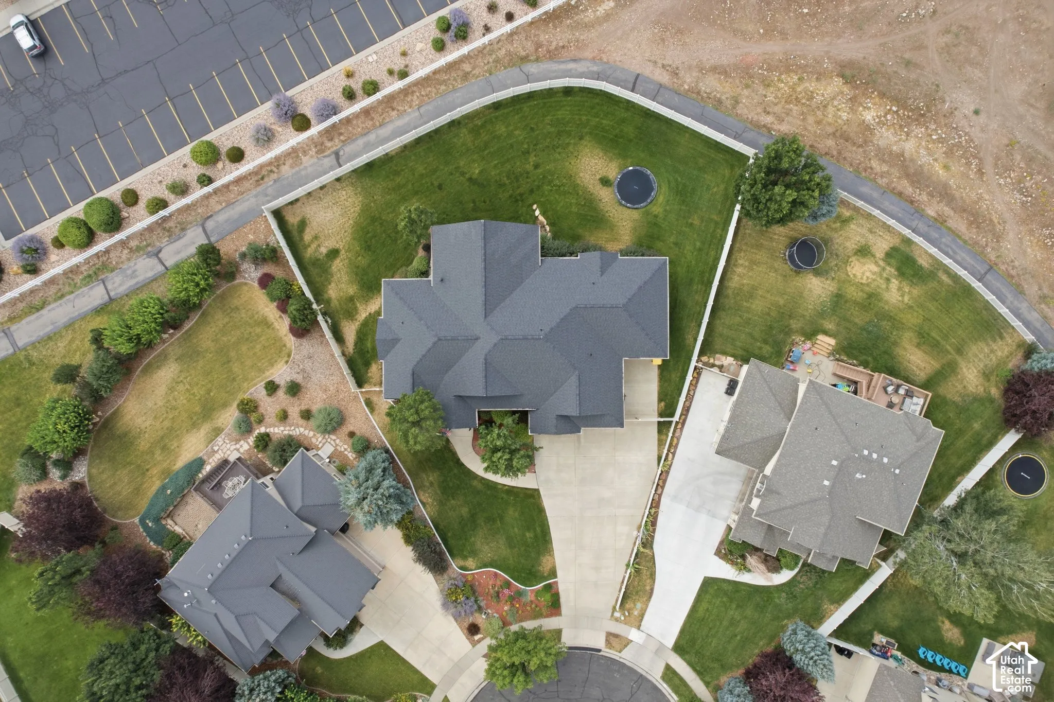 Expansive property featuring a large grass lawn, mature trees, and landscaping