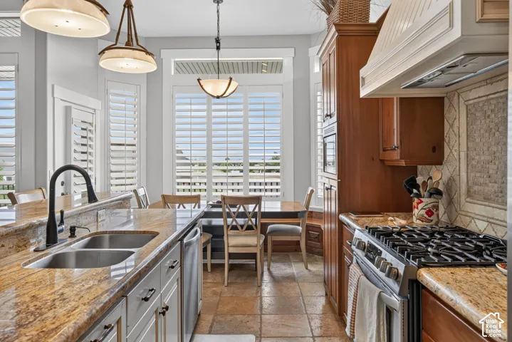 Kitchen featuring integrated appliances, shaker-style cabinetry, and a gas range
