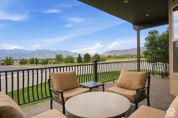 Covered patio with recessed lighting, stone-finish flooring, and wrought iron railing